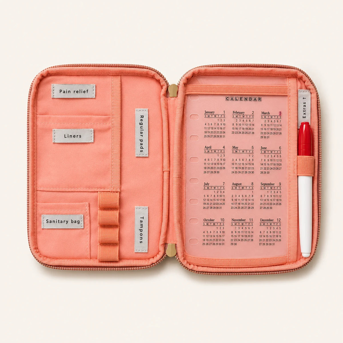 Inside the LunnaLu Small Period Organiser, open flat with a peach lining. Labelled sections for pain relief, liners, regular pads, sanitary bag and tampons, four elastic tampon loops, a dated calendar and a permanent marker in its loop.